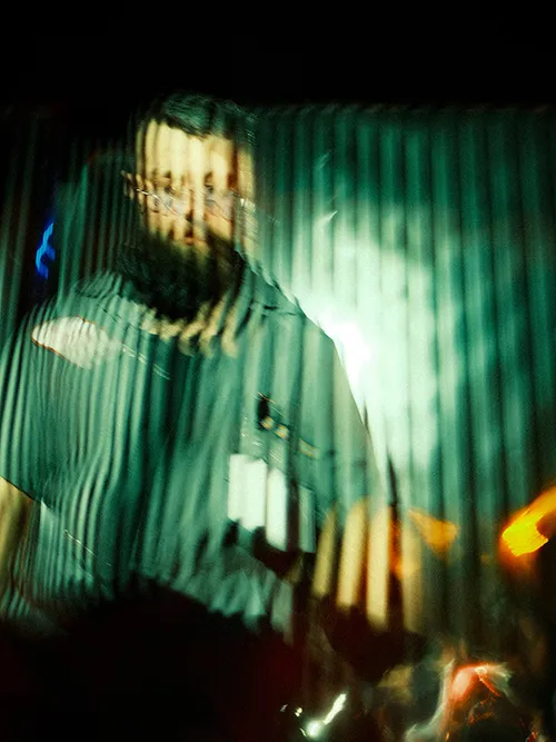 Abstract image of a person with a beard and glasses