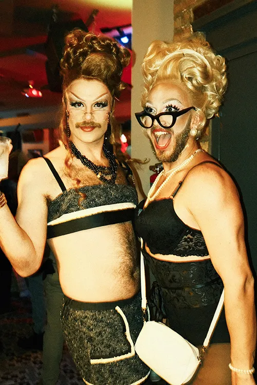 Two Drag queens with big hear, glasses and beards